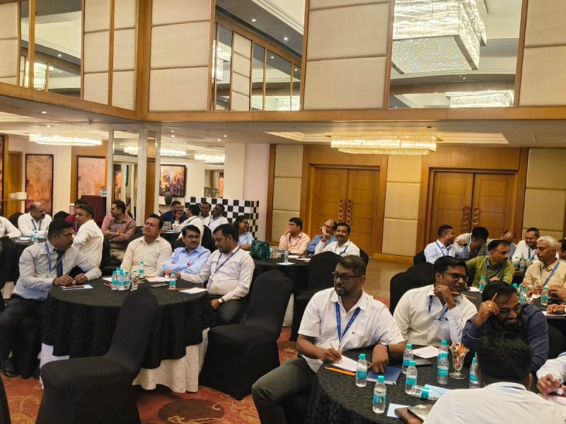 A full room of professionals in a live session